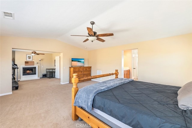 33734 Wild Horse Way, Yucaipa, CA 92399 - bedroom featuring vaulted ceiling, light carpet, baseboards, a ceiling fan, and a glass covered fireplace