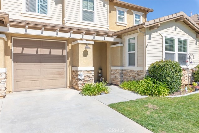 33734 Wild Horse Way, Yucaipa, CA 92399 - view of property with stone siding, an attached garage, driveway, and stucco siding