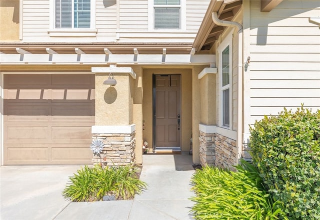 33734 Wild Horse Way, Yucaipa, CA 92399 - property entrance with stone siding, a garage, and stucco siding