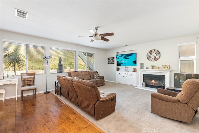 33734 Wild Horse Way, Yucaipa, CA 92399 - living room with ceiling fan, baseboards, a glass covered fireplace, and wood finished floors