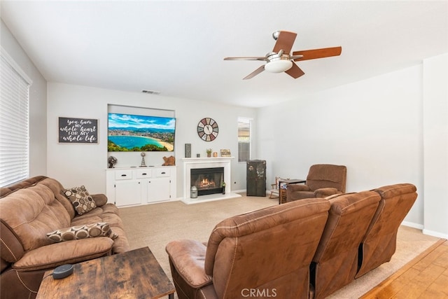 33734 Wild Horse Way, Yucaipa, CA 92399 - living room with a ceiling fan, a glass covered fireplace, baseboards, and light wood-style flooring