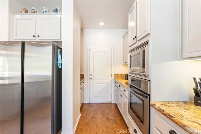 33734 Wild Horse Way, Yucaipa, CA 92399 - kitchen featuring stainless steel appliances, light wood finished floors, white cabinets, light stone countertops, and recessed lighting