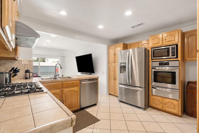 915 S Danehurst Ave, Glendora, CA 91740 - kitchen featuring appliances with stainless steel finishes, a warming drawer, a sink, tile countertops, and a peninsula