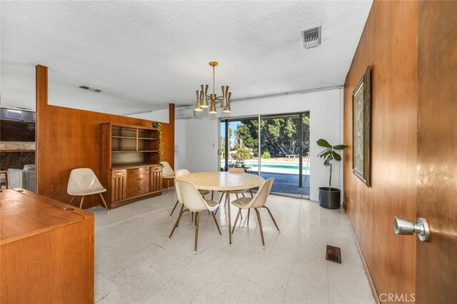 7160 Bel Air St, Corona, CA 92881 - dining space featuring light floors, wooden walls, a chandelier, and a textured ceiling