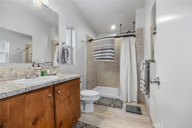7160 Bel Air St, Corona, CA 92881 - bathroom featuring vanity, tiled shower, toilet, and wood finished floors