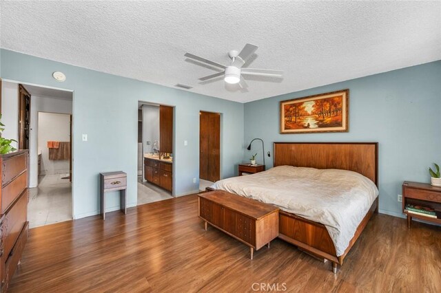7160 Bel Air St, Corona, CA 92881 - bedroom with wood finished floors, connected bathroom, a textured ceiling, baseboards, and ceiling fan