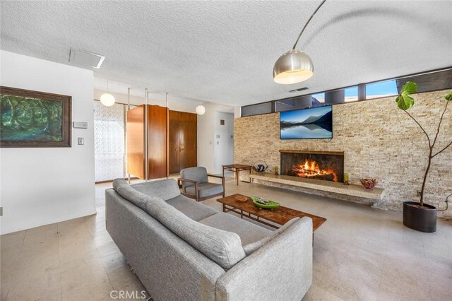 7160 Bel Air St, Corona, CA 92881 - living area with a stone fireplace and a textured ceiling