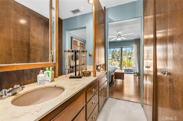7160 Bel Air St, Corona, CA 92881 - bathroom featuring double vanity, a ceiling fan, and a textured ceiling