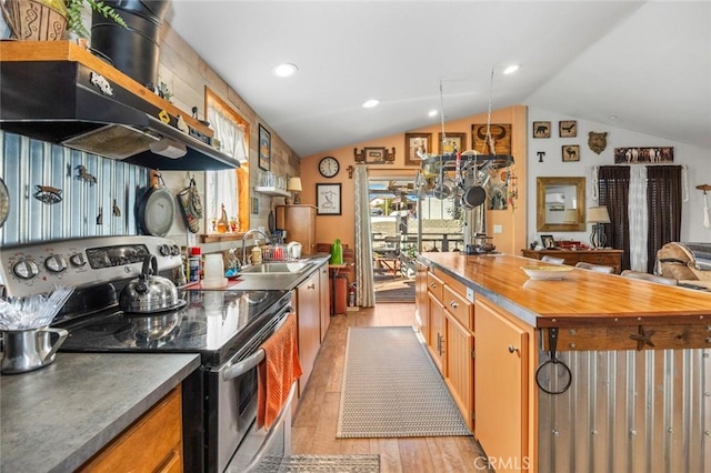 7160 Bel Air St, Corona, CA 92881 - kitchen featuring stainless steel range with electric stovetop, exhaust hood, a sink, vaulted ceiling, and butcher block counters