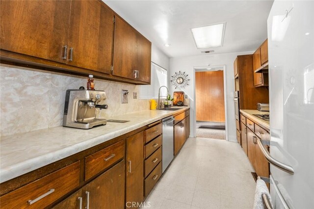 7160 Bel Air St, Corona, CA 92881 - kitchen with a sink, stainless steel appliances, light countertops, decorative backsplash, and under cabinet range hood