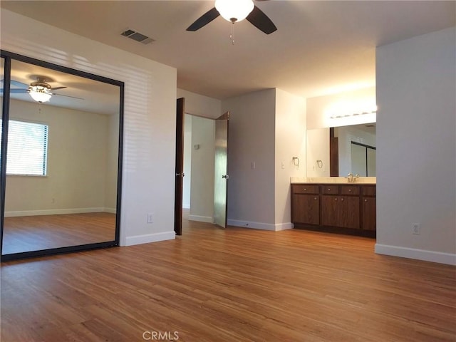 27535 Lakeview Dr Unit 14, Helendale, CA 92342 - unfurnished bedroom with light wood finished floors, baseboards, and a sink
