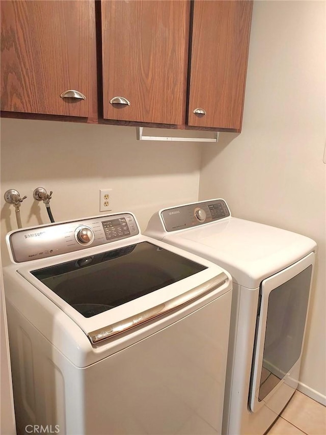 27535 Lakeview Dr Unit 14, Helendale, CA 92342 - laundry room with separate washer and dryer, cabinet space, and light tile patterned flooring