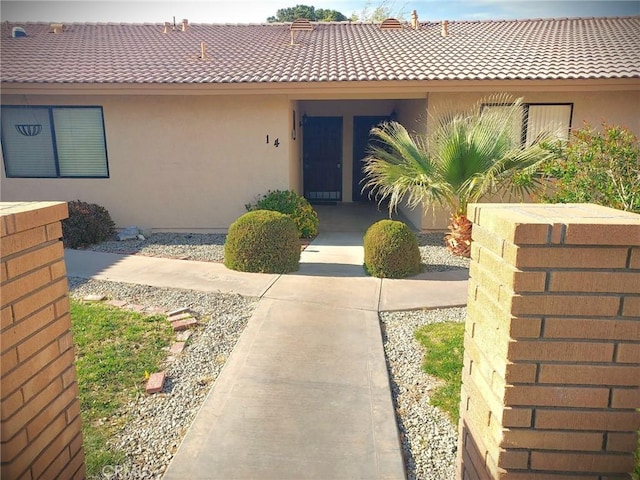 27535 Lakeview Dr Unit 14, Helendale, CA 92342 - property entrance with stucco siding and a tiled roof