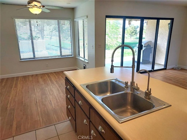 27535 Lakeview Dr Unit 14, Helendale, CA 92342 - kitchen featuring a sink, light wood-type flooring, light countertops, baseboards, and ceiling fan