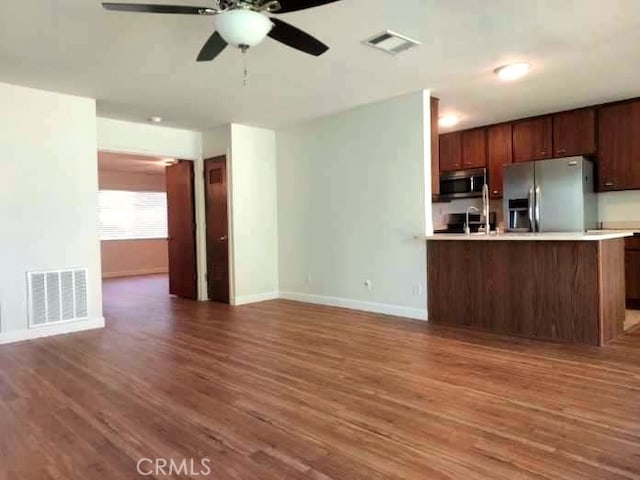 27535 Lakeview Dr Unit 14, Helendale, CA 92342 - kitchen featuring appliances with stainless steel finishes, light countertops, ceiling fan, and wood finished floors