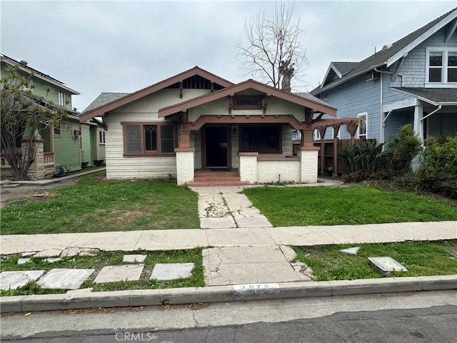 bungalow-style home featuring a front yard