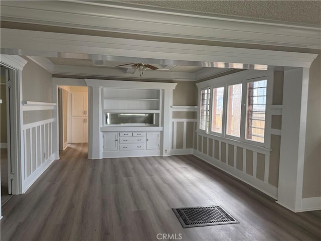 unfurnished living room featuring wood finished floors, visible vents, ceiling fan, and crown molding