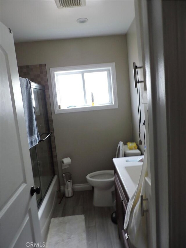 9472 Woodale Ave, Arleta, CA 91331 - full bath featuring wood finished floors, a wealth of natural light, toilet, and vanity