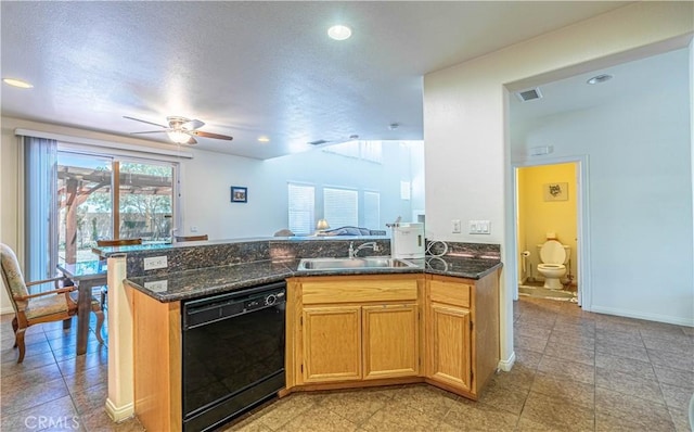 kitchen featuring a peninsula, ceiling fan, black dishwasher, lofted ceiling, and a sink