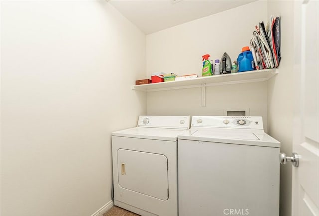 laundry area featuring baseboards, separate washer and dryer, and laundry area