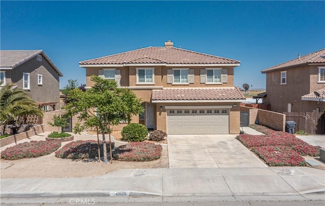 view of front of house with concrete driveway, a chimney, fence, an attached garage, and a tiled roof