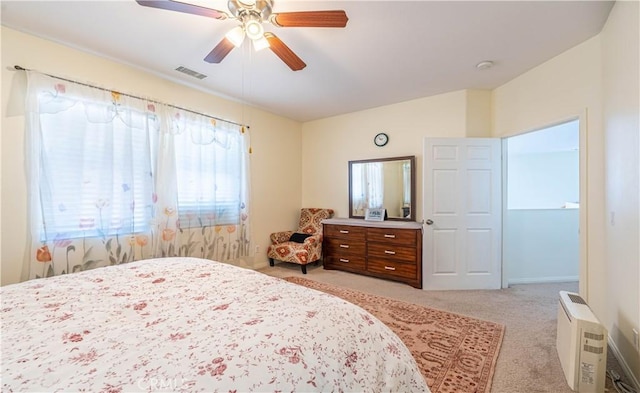 carpeted bedroom featuring ceiling fan and visible vents