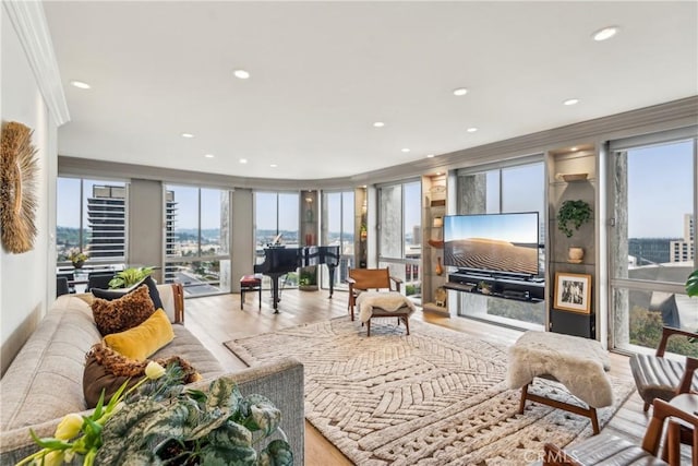living room featuring ornamental molding, wood finished floors, and recessed lighting