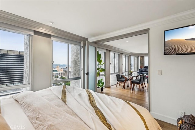 800 W 1st St Unit 1803, Los Angeles, CA 90012 - bedroom featuring wood finished floors, baseboards, ornamental molding, multiple windows, and recessed lighting