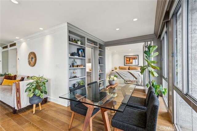 800 W 1st St Unit 1803, Los Angeles, CA 90012 - dining space with crown molding, light wood finished floors, recessed lighting, and baseboards