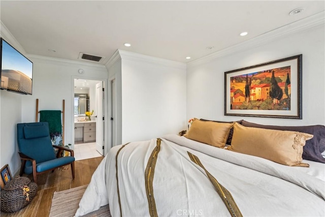 800 W 1st St Unit 1803, Los Angeles, CA 90012 - bedroom featuring wood finished floors, ornamental molding, recessed lighting, and connected bathroom