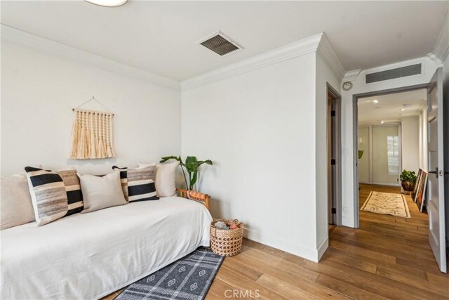 800 W 1st St Unit 1803, Los Angeles, CA 90012 - bedroom featuring crown molding, wood finished floors, and baseboards