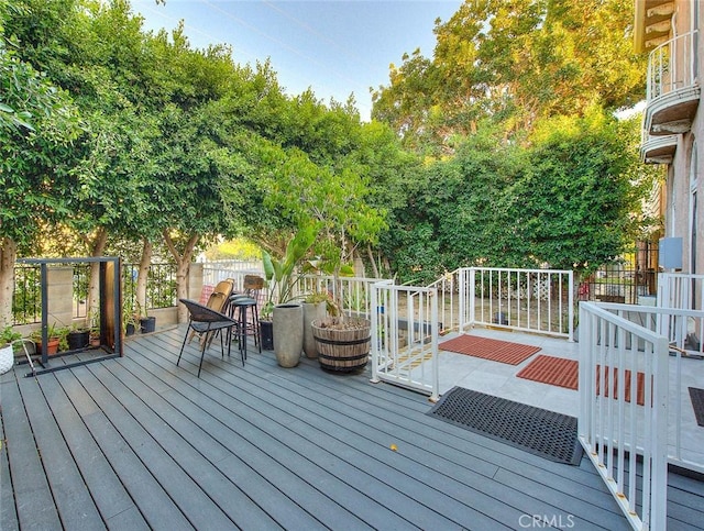 wooden terrace featuring fence