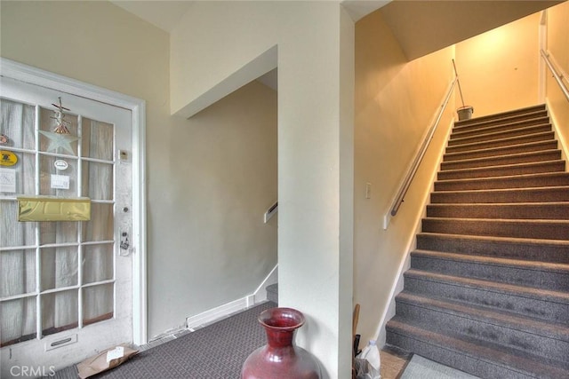 stairs with baseboards and carpet