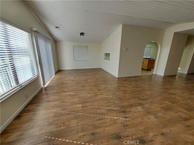 327 Mccarthy Ave, Oceano, CA 93445 - empty room with wood finished floors, arched walkways, and baseboards