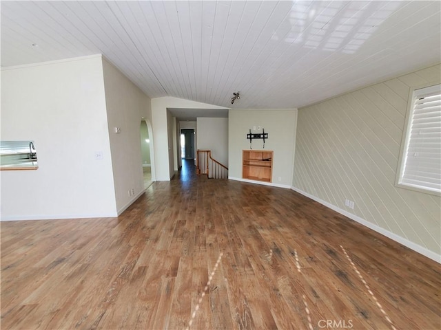 327 Mccarthy Ave, Oceano, CA 93445 - unfurnished living room with hardwood / wood-style floors, arched walkways, and baseboards