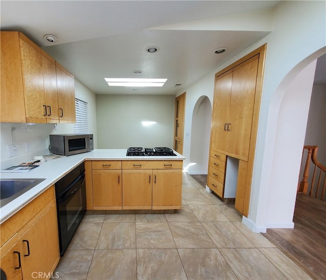 327 Mccarthy Ave, Oceano, CA 93445 - kitchen featuring black appliances, arched walkways, a peninsula, and light countertops