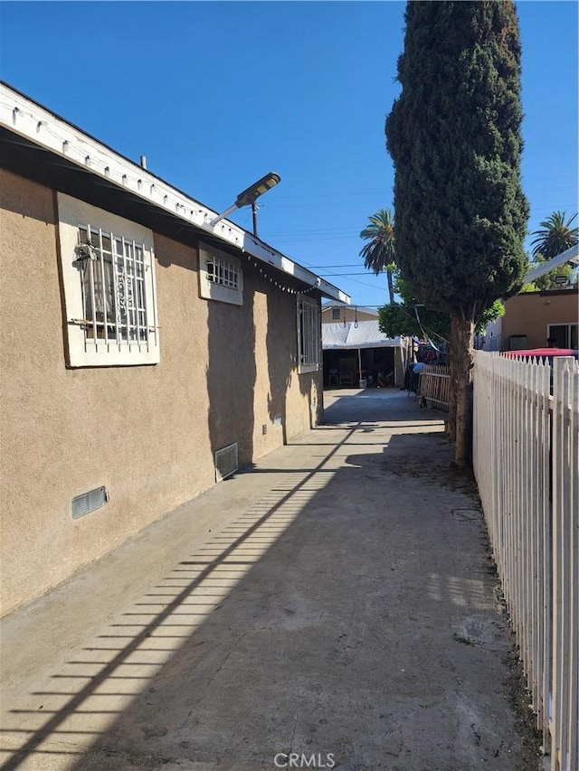 242 E 92nd St, Los Angeles, CA 90003 - view of property exterior featuring stucco siding and crawl space