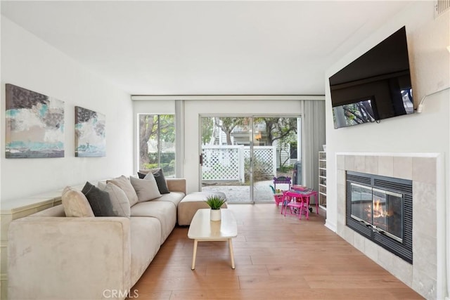 22230 S Vermont Ave Unit 102B, Torrance, CA 90502 - living room with wood finished floors, healthy amount of natural light, and a tile fireplace