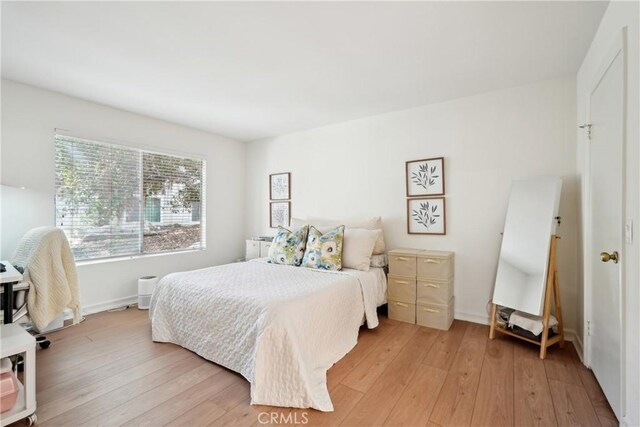 22230 S Vermont Ave Unit 102B, Torrance, CA 90502 - bedroom with light wood finished floors and baseboards