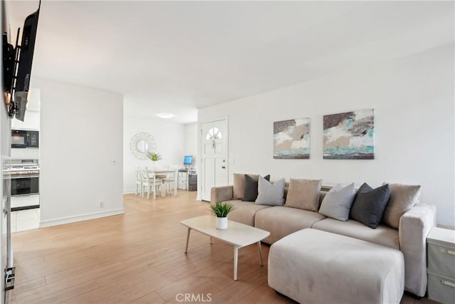 22230 S Vermont Ave Unit 102B, Torrance, CA 90502 - living area featuring light wood-style flooring and baseboards