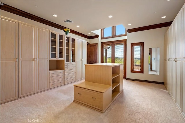 walk in closet with visible vents and light colored carpet