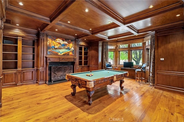 rec room with a fireplace with flush hearth, crown molding, built in shelves, coffered ceiling, and wooden ceiling