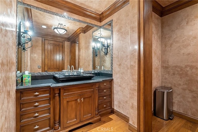 bathroom featuring baseboards, wood finished floors, and crown molding