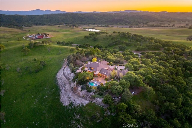 drone / aerial view featuring a mountain view and a rural view
