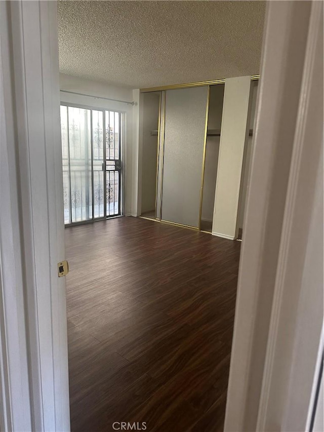 1524 Acacia St Unit 3, Alhambra, CA 91801 - unfurnished bedroom featuring dark wood finished floors, a textured ceiling, a closet, and baseboards
