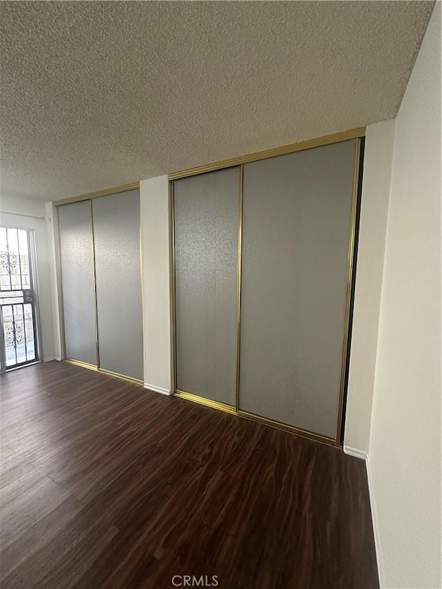 1524 Acacia St Unit 3, Alhambra, CA 91801 - unfurnished bedroom with two closets, wood finished floors, a textured ceiling, and a decorative wall