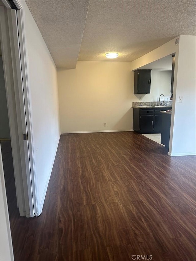 1524 Acacia St Unit 3, Alhambra, CA 91801 - unfurnished living room with dark wood finished floors, a textured ceiling, a sink, and baseboards