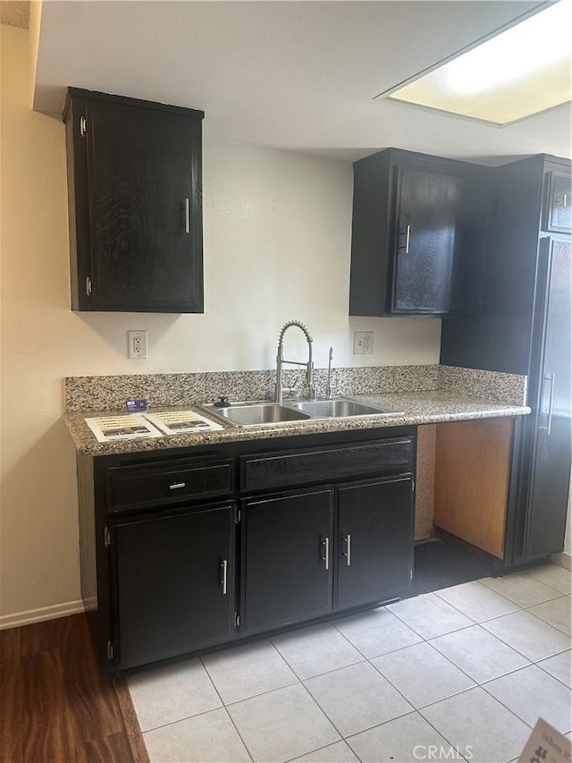 1524 Acacia St Unit 3, Alhambra, CA 91801 - kitchen with a sink, dark cabinets, light countertops, light tile patterned floors, and baseboards