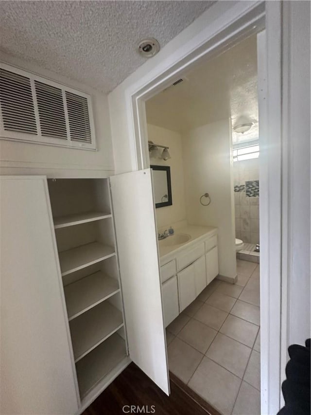 1524 Acacia St Unit 3, Alhambra, CA 91801 - full bath with a stall shower, a textured ceiling, vanity, toilet, and tile patterned flooring