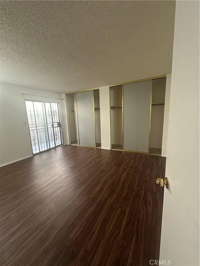1524 Acacia St Unit 3, Alhambra, CA 91801 - unfurnished bedroom featuring multiple closets, a textured ceiling, and dark wood-type flooring